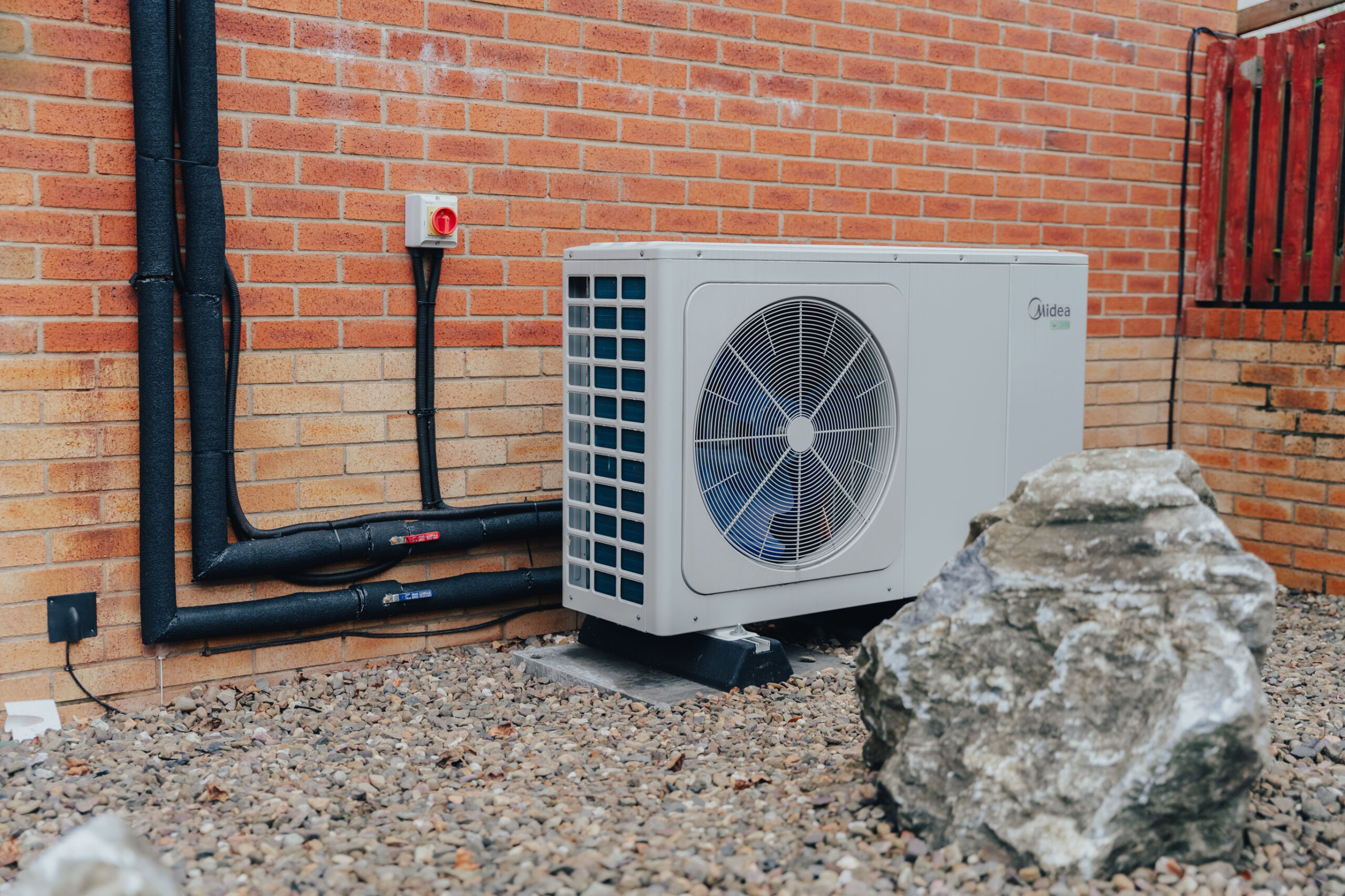 heat pump outside red brick house
