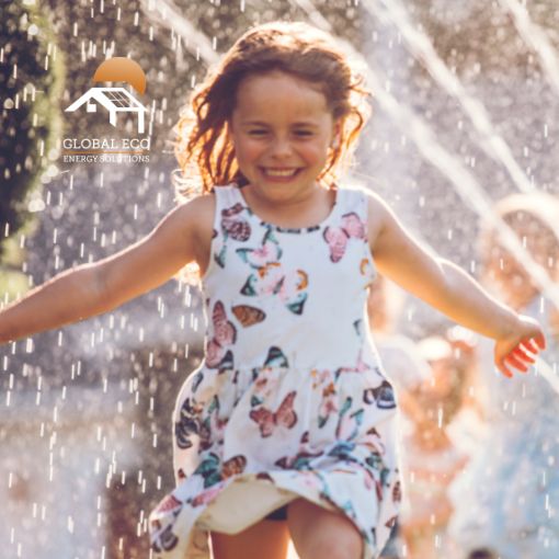 Should You Turn Your Heat Pump Off in Summer? Little girl running through water sprinkler